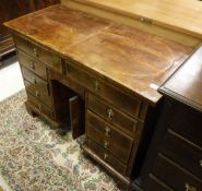 A walnut and feather-banded kneehole desk in the 18th Century manner,