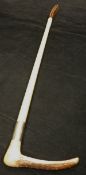 A child's riding crop with antler handle and steel ferrule with plaited string shaft