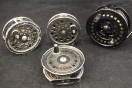 A collection of four assorted fly reels to include an Okuma "Integrity" salmon fly reel,