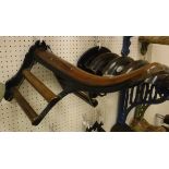 A painted cast iron and mahogany mounted Musgrave wall-mounted saddle rack with associated bridle