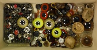 A box containing assorted glass eyes of varying colours and sizes