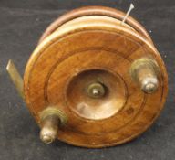 A Gamage 3½"" diameter spine back wooden fishing reel