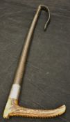 A gentleman's riding crop with antler handle and plated ferrule inscribed "ENSC" above a plaited