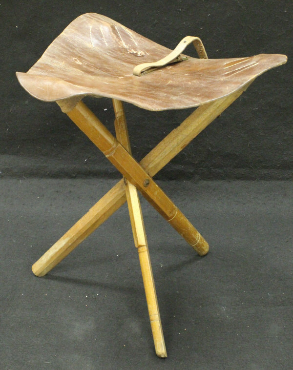 A leather and ash framed folding stool