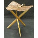 A leather and ash framed folding stool
