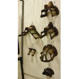 Four various cast iron and mahogany mounted bridle racks by Musgrave,