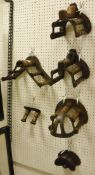Four various cast iron and mahogany mounted bridle racks by Musgrave,
