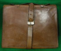 A vintage leather writing folder with strap