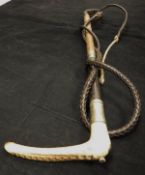 A gentleman's riding crop with antler handle and steel ferrule,