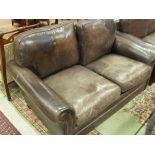 A pair of Laura Ashley brown leather two seat sofas