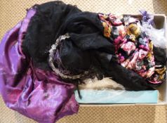 A box containing a velvet and black lace dress, a glass bead decorated hair piece,