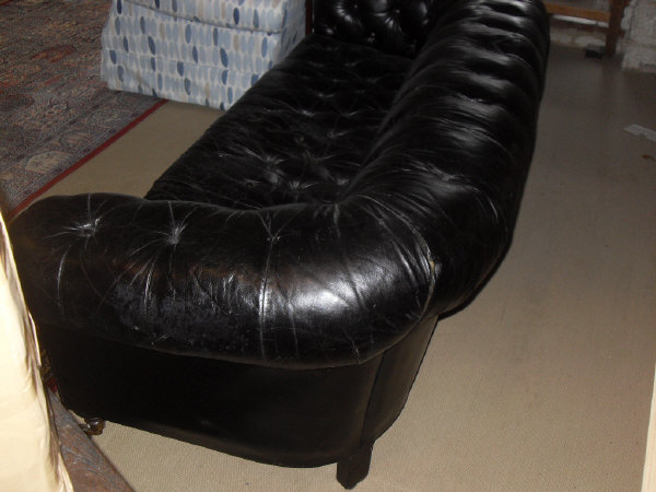 A late Victorian buttoned leather upholstered Chesterfield sofa on turned legs to brass caps and - Image 11 of 12