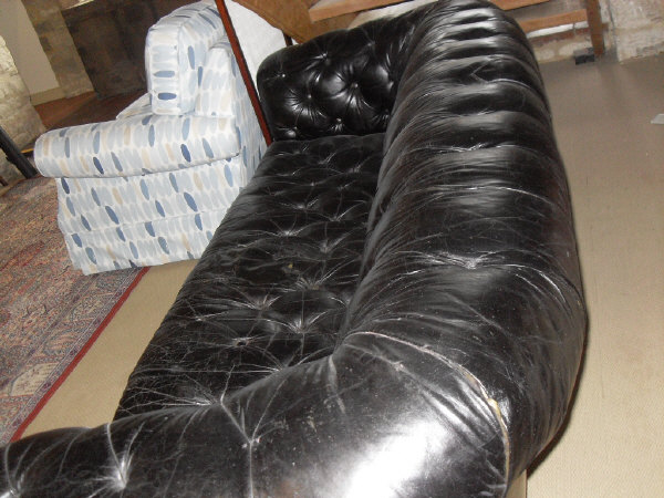 A late Victorian buttoned leather upholstered Chesterfield sofa on turned legs to brass caps and - Image 12 of 12