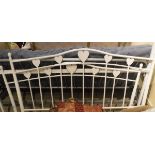 A modern white painted metal framed double bedstead with loveheart motif decoration and a modern