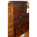 A mahogany bookcase in the Chippendale taste with two glazed doors enclosing four shelves on a base