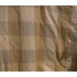 A pair of cotton interlined curtains of gold checked design and a further curtain together with a