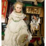 A Victorian wax doll with dress and hat,