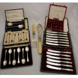 A box containing a cased set of six Edwardian silver tea spoons (London 1903) with trefid style