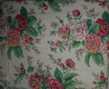 A vintage bed throw, the front with floral sprays on a cream ground,