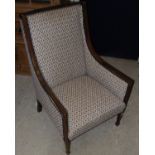 An Edwardian mahogany and satinwood inlaid armchair of swept form in a cream ground foliate