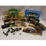 A box containing various model trains including a Peco starter track set,