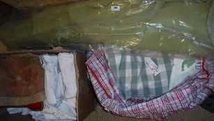 A box of assorted vintage table linens to include a red tea cosy with embroidered floral decoration,