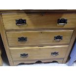 A satin walnut chest of three drawers,