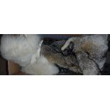 A box containing a mink fur stole, various fox fur tippets,