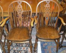 A set of six beech and elm wheel and stick back elbow chairs by "T. W.