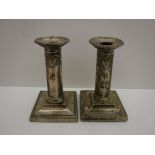 A pair of Edwardian silver candlesticks with harebell and bow decoration,