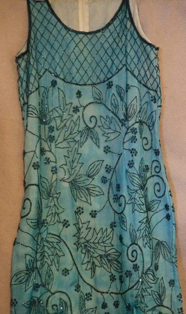 A circa 1920's full length evening dress in turquoise chiffon with hand-sewn bead decoration