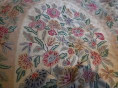 A French crewel work type rug, the central panel decorated with floral sprays in pink,