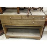 An oak dressing chest in the Heals manner with three-quarter gallery top and two short over long