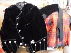 A child's kilt and velvet jacket, together with two waistcoats, a pair of tartan shorts, sash,
