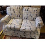 A Laura Ashley blue and cream ground upholstered scroll arm two seat sofa