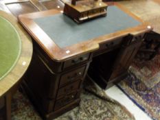 A mahogany kneehole desk in the 19th Century manner,
