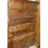 A 20th Century pine dresser with three shelves and two drawers above two cupboard doors