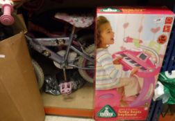 An IKEA child's painted table and two chairs, a Barbie child's bike, a Balin Zoobs Drive body board,