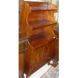 A late Victorian mahogany waterfall bookcase cabinet with three shelves above the two inlaid