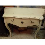 A cream painted serpentine fronted single drawer side table,