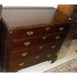 An oak chest in the George III manner of four long graduated drawers flanked by fluted quarter cut