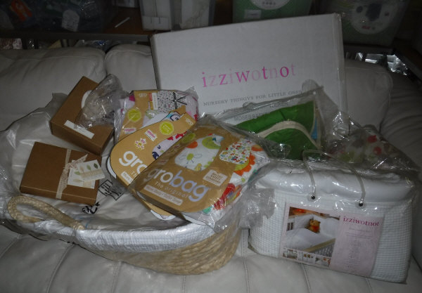 An Izzi Wotnot moses basket, an Ella & Otto playmat, various gro bag sleeping bags, a bedding bale,