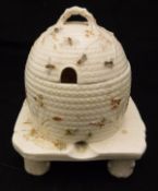 A Belleek honey pot of beehive form,