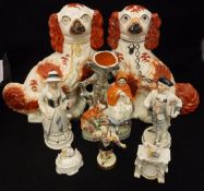 A pair of 19th Century Staffordshire spaniel ornaments,
