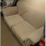 A modern cream upholstered two seat scroll arm sofa