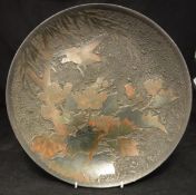 A 19th Century Japanese cloisonne on porcelain charger depicting a bird amongst blossoming foliage,
