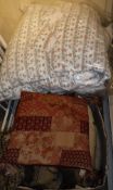 A box of assorted scatter cushions in red and brown,