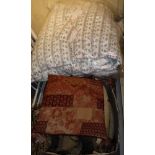 A box of assorted scatter cushions in red and brown,