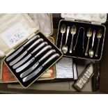 A box containing a case set of six silver teaspoons, together with matching sugar tongs,