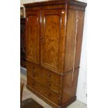 A Victorian mahogany linen press with two doors above two short and two long drawers to plinth base